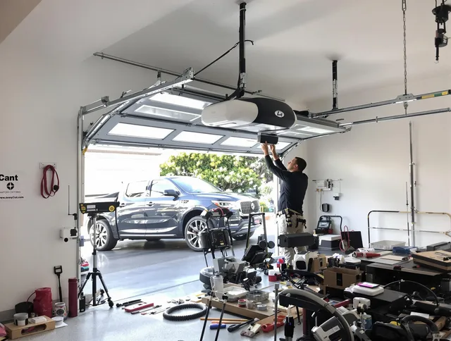 Coconut Creek Garage Door Repair specialist installing smart garage door opener system in Coconut Creek home